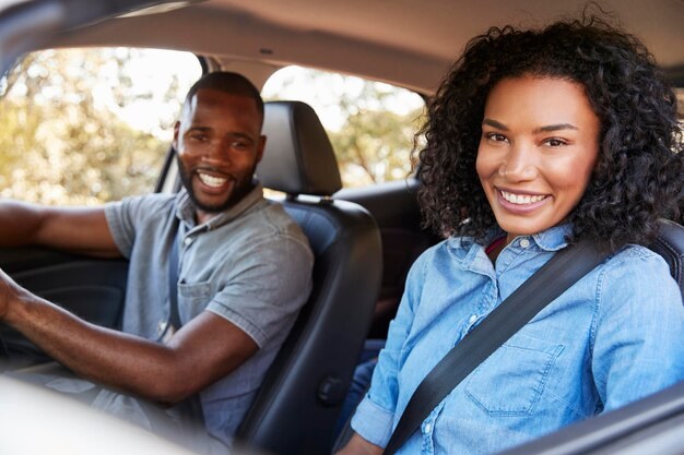 Smiling couple sitting in their car